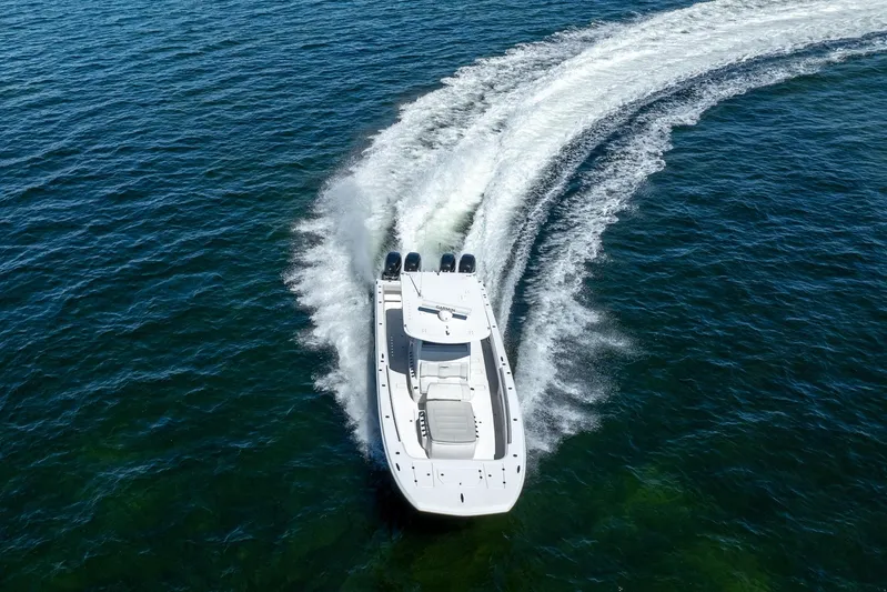  Yacht Photos Pics 2019 Invincible 37 Catamaran cruising on open water, creating a dynamic wake.