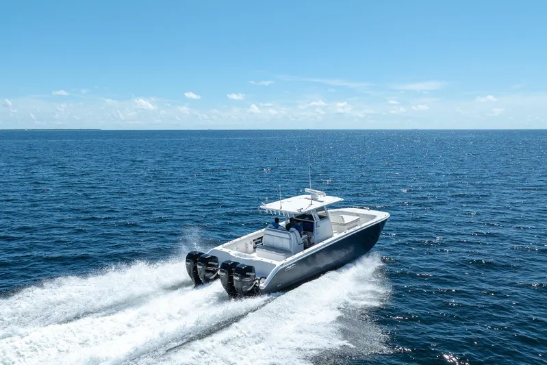  Yacht Photos Pics 2019 Invincible 37 Catamaran cruising on open ocean under clear blue sky.