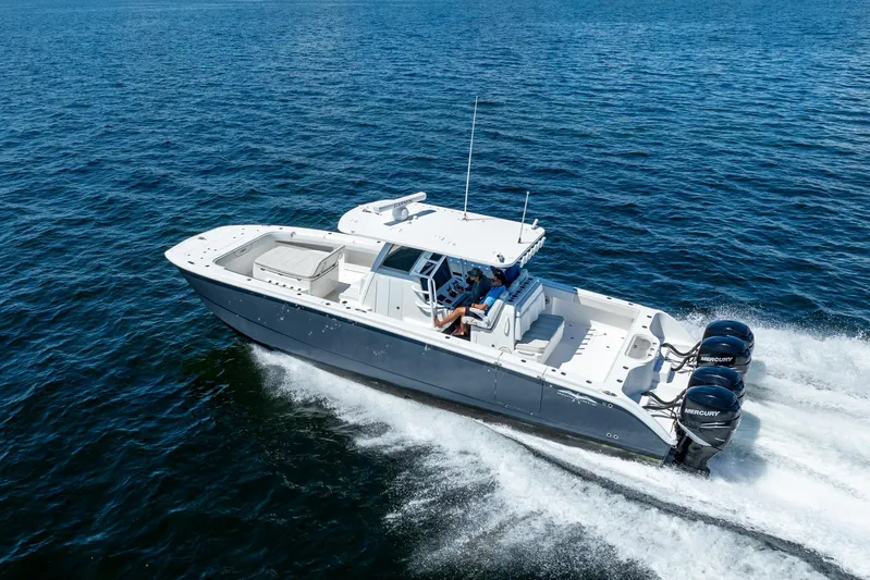  Yacht Photos Pics 2019 Invincible 37 Catamaran cruising on open water with twin Mercury engines.