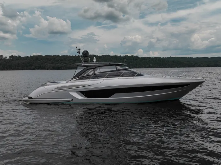 Maximus Yacht Photos Pics 2023 Riva 56 Rivale luxury yacht on a serene lake with cloudy sky.