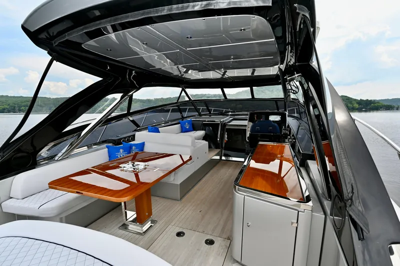 Maximus Yacht Photos Pics Luxurious interior of the 2023 Riva 56 Rivale yacht with elegant seating and wooden table.