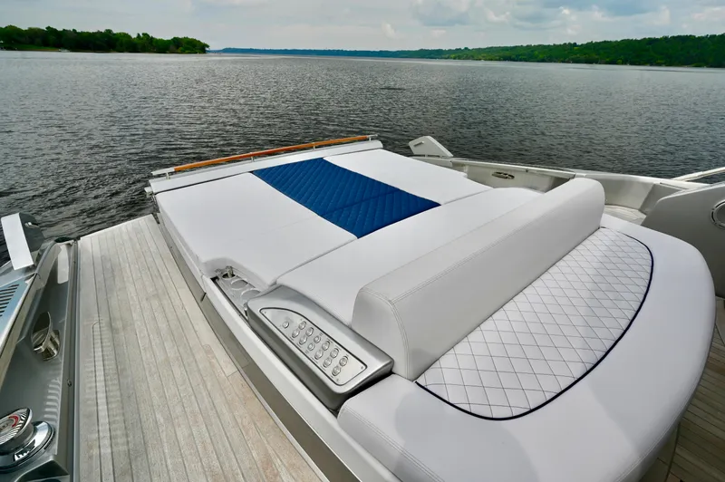 Maximus Yacht Photos Pics Luxury sunbed on the 2023 Riva 56 Rivale yacht, overlooking serene waters.
