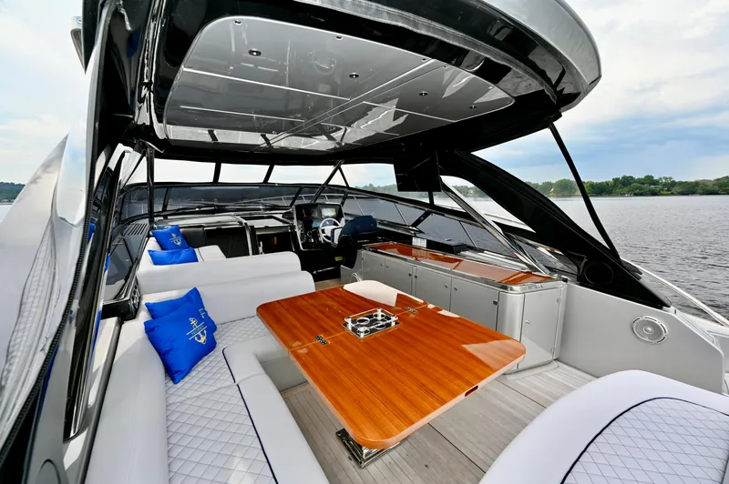 Maximus Yacht Photos Pics Luxurious interior of 2023 Riva 56 Rivale yacht with elegant seating and wooden table.