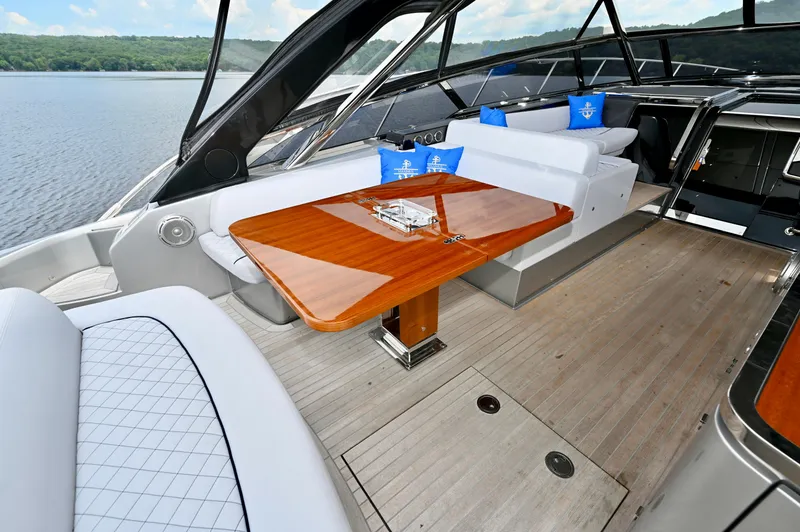 Maximus Yacht Photos Pics Luxurious interior of 2023 Riva 56 Rivale yacht with elegant seating and wooden table.