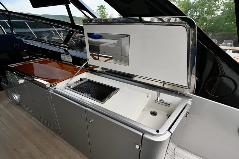 Maximus Yacht Photos Pics Outdoor kitchen area on 2023 Riva 56 Rivale yacht with sink and grill.