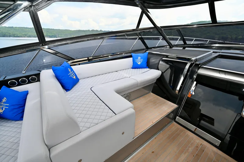 Maximus Yacht Photos Pics Luxurious seating area on the 2023 Riva 56 Rivale yacht with blue accent pillows.
