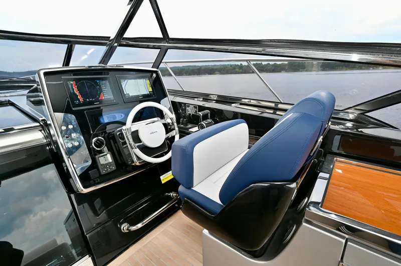 Maximus Yacht Photos Pics 2023 Riva 56 Rivale yacht cockpit with modern navigation system and luxurious seating.