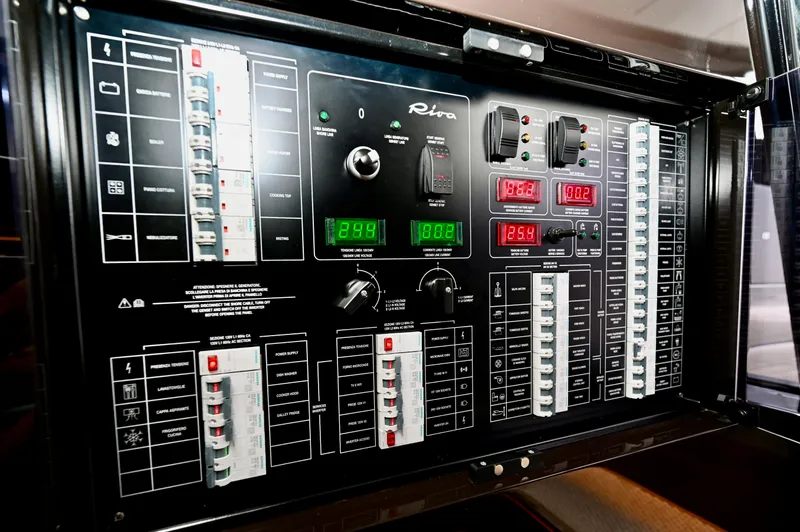 Maximus Yacht Photos Pics Control panel of 2023 Riva 56 RIVALE yacht with various switches and digital displays.