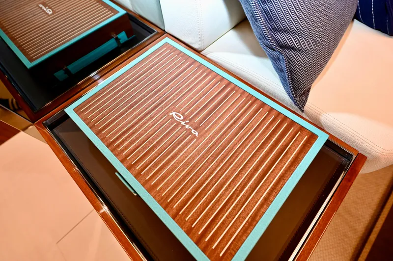 Maximus Yacht Photos Pics 2023 Riva 56 Rivale interior detail with branded wooden table and cushion.