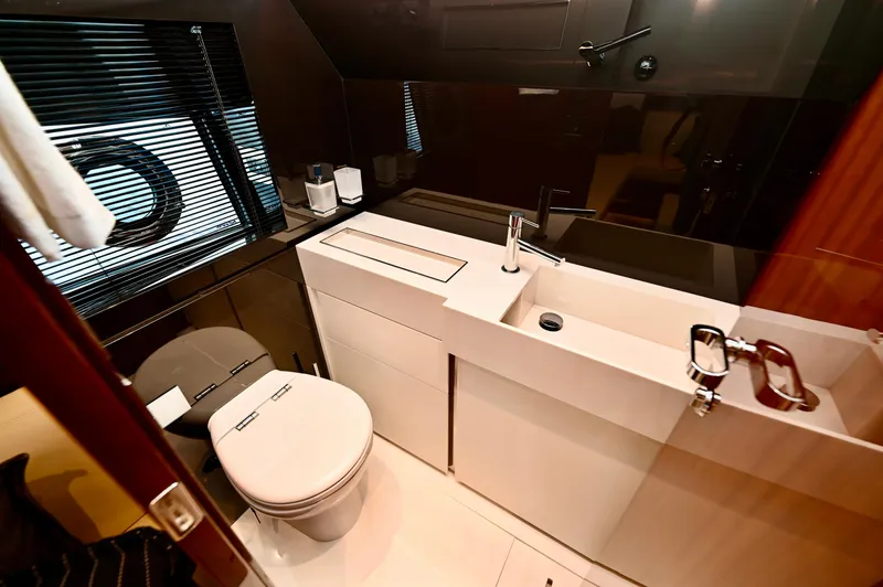 Maximus Yacht Photos Pics Luxurious bathroom in 2023 Riva 56 Rivale yacht with modern fixtures and sleek design.