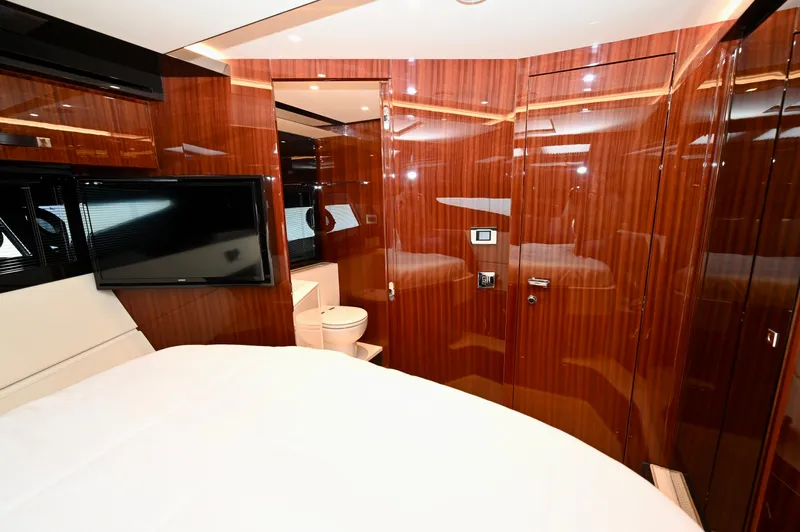 Maximus Yacht Photos Pics Luxurious interior cabin of 2023 Riva 56 Rivale yacht with wood paneling and modern amenities.