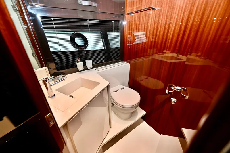 Maximus Yacht Photos Pics Luxurious bathroom in 2023 Riva 56 Rivale yacht with modern fixtures and wooden accents.