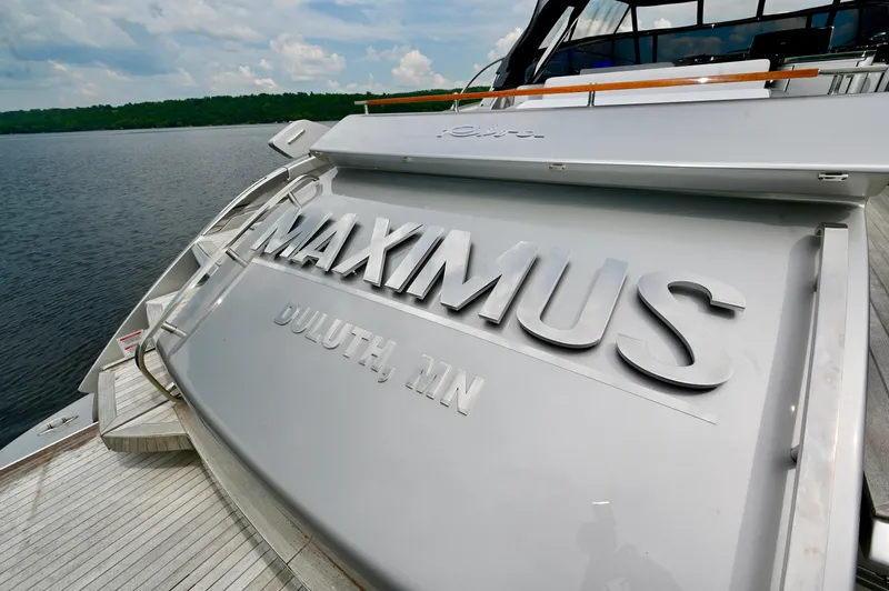 Maximus Yacht Photos Pics 2023 Riva 56 Rivale yacht named Maximus docked on a serene lake.