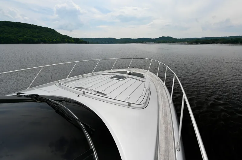 Maximus Yacht Photos Pics 2023 Riva 56 RIVALE yacht cruising on a serene lake.