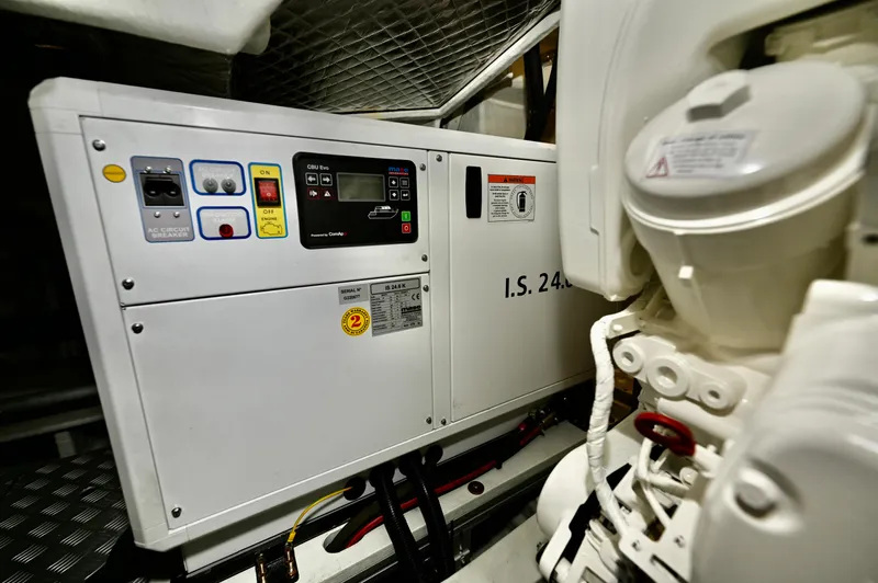 Maximus Yacht Photos Pics Engine room of 2023 Riva 56 Rivale yacht with generator and control panel.