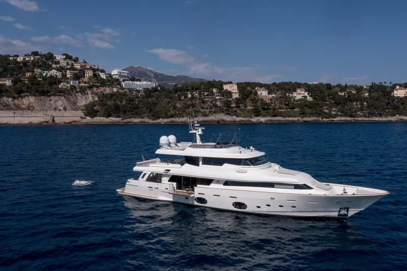 Centurion Yacht Photos Pics Luxurious 2013 Custom Line Navetta 33 Crescendo yacht cruising near scenic coastline.