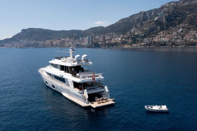 Centurion Yacht Photos Pics Luxurious 2013 Custom Line Navetta 33 Crescendo yacht anchored near scenic coastline.