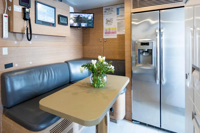 Centurion Yacht Photos Pics Luxurious yacht interior with seating, table, and stainless steel fridge; Custom Line Navetta 33 Crescendo, 2013.