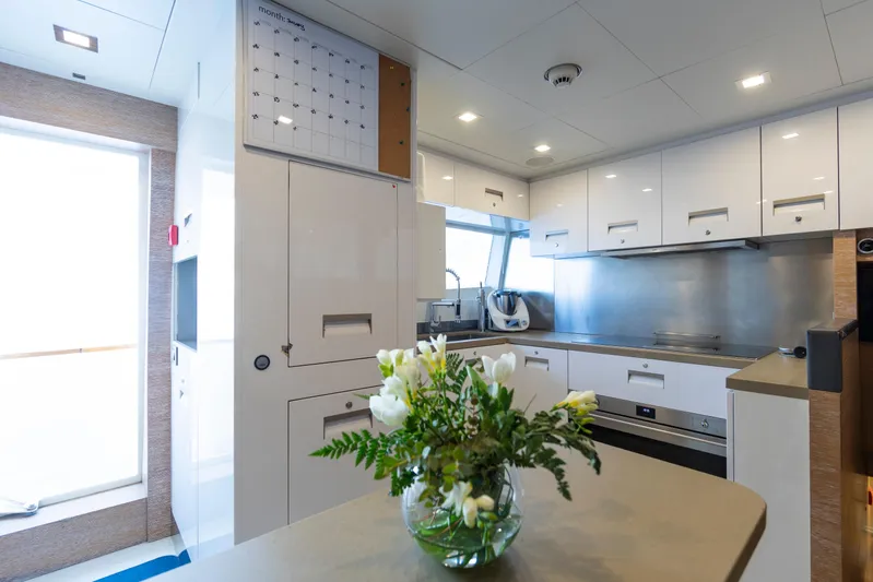Centurion Yacht Photos Pics Modern kitchen interior on 2013 Custom Line Navetta 33 Crescendo yacht with floral centerpiece.