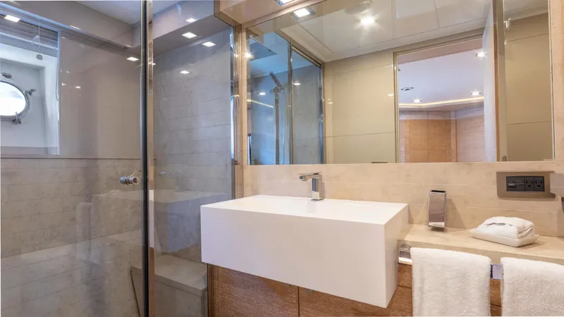 Centurion Yacht Photos Pics Luxurious bathroom on 2013 Custom Line Navetta 33 Crescendo yacht, featuring modern sink and glass shower.