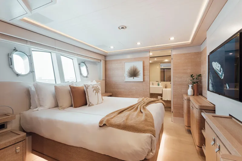 Centurion Yacht Photos Pics Luxurious bedroom interior on 2013 Custom Line Navetta 33 Crescendo yacht, featuring elegant decor and natural light.
