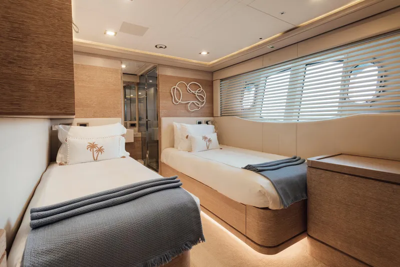Centurion Yacht Photos Pics Luxurious twin cabin on 2013 Custom Line Navetta 33 Crescendo yacht, featuring elegant decor and porthole windows.