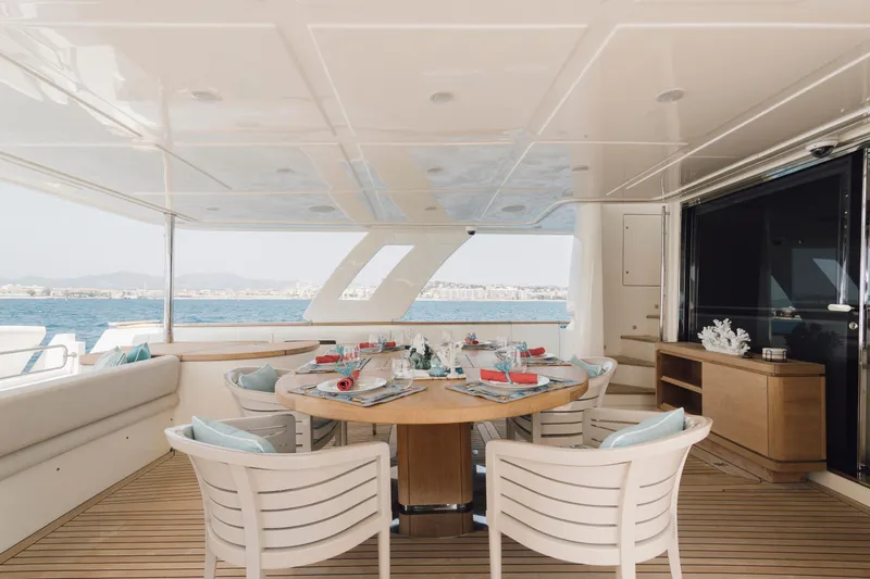 Centurion Yacht Photos Pics Luxurious dining area on 2013 Custom Line Navetta 33 Crescendo yacht, featuring elegant table setting.