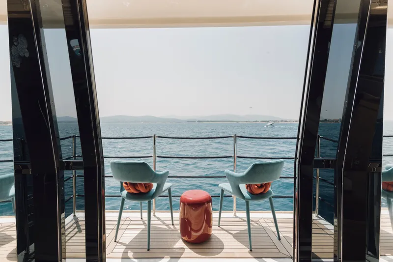 Centurion Yacht Photos Pics Luxury yacht deck with chairs, table, and ocean view on Custom Line Navetta 33 Crescendo, 2013.