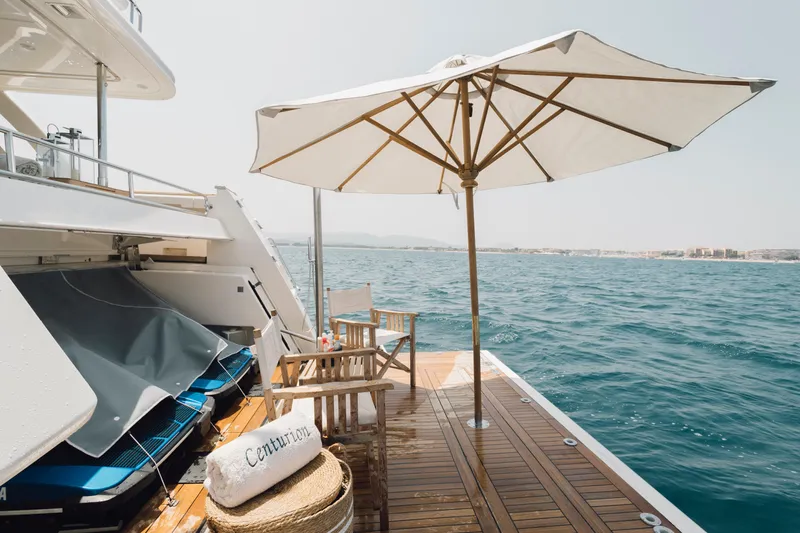 Centurion Yacht Photos Pics Luxury yacht deck with umbrella, chairs, and sea view, Custom Line Navetta 33 Crescendo 2013.