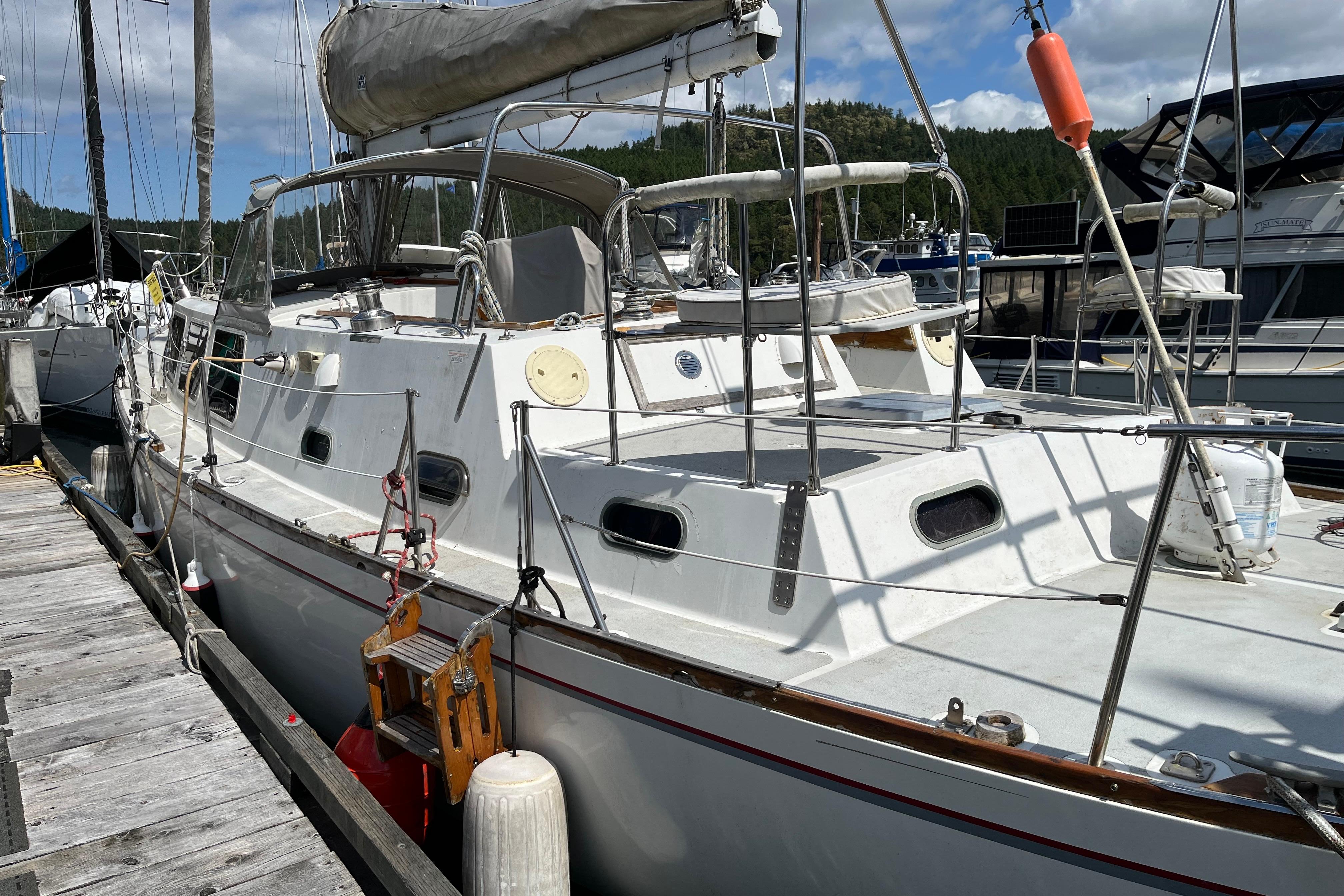 1972 CAL 2-46 sailboat docked at marina under blue sky.
