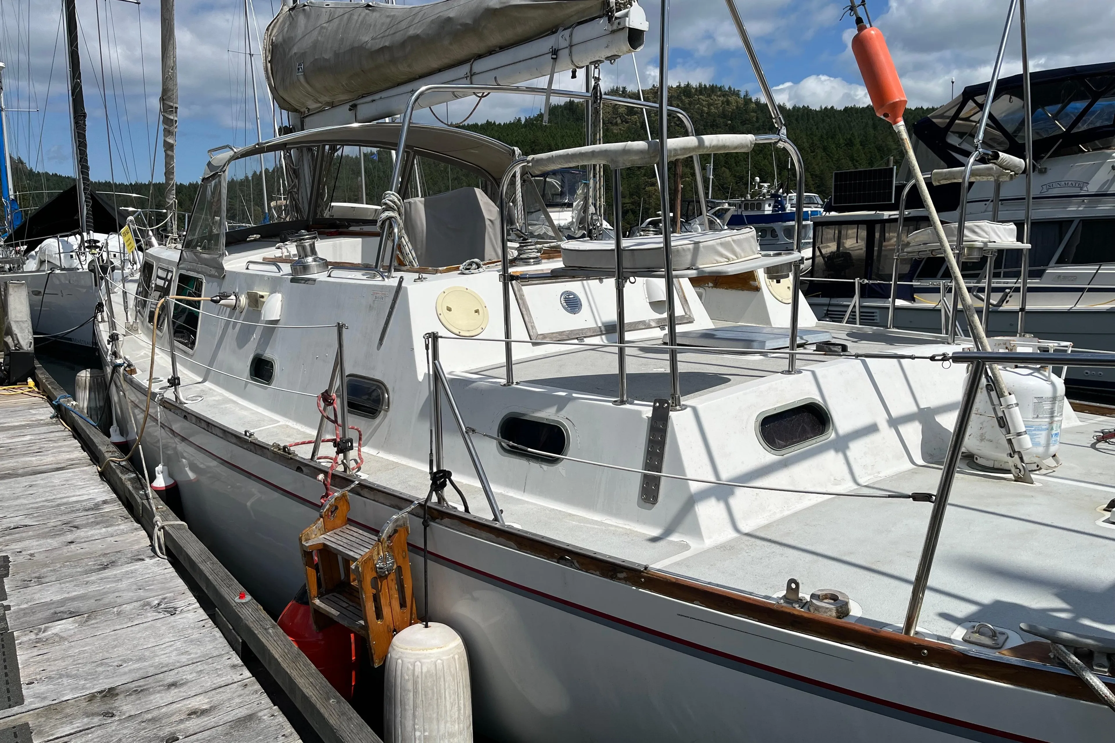 1972 CAL 2-46 sailboat docked at marina under blue sky.