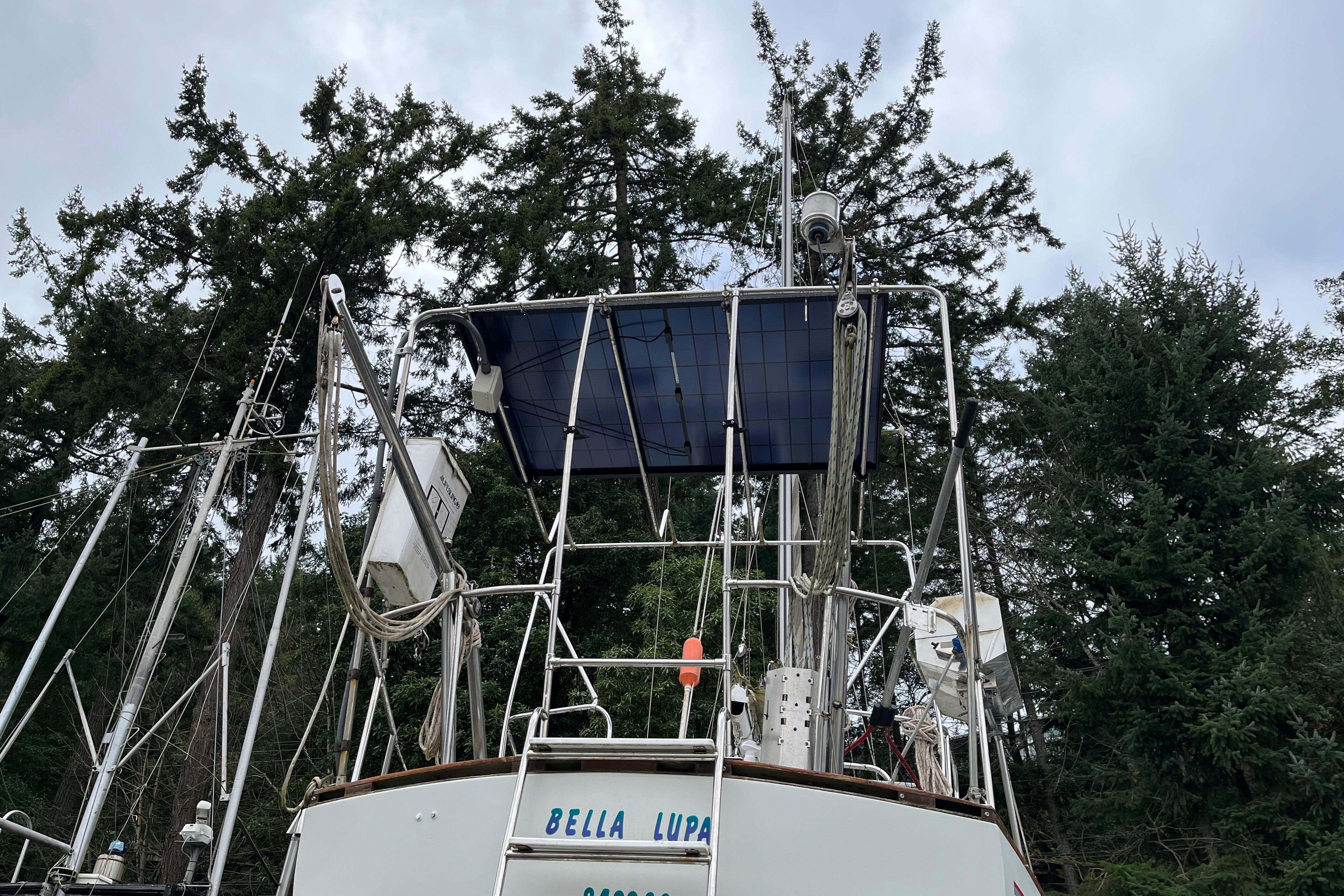 Sailboat with solar panels and equipment, surrounded by tall trees, CAL 2-46 model, 1972.
