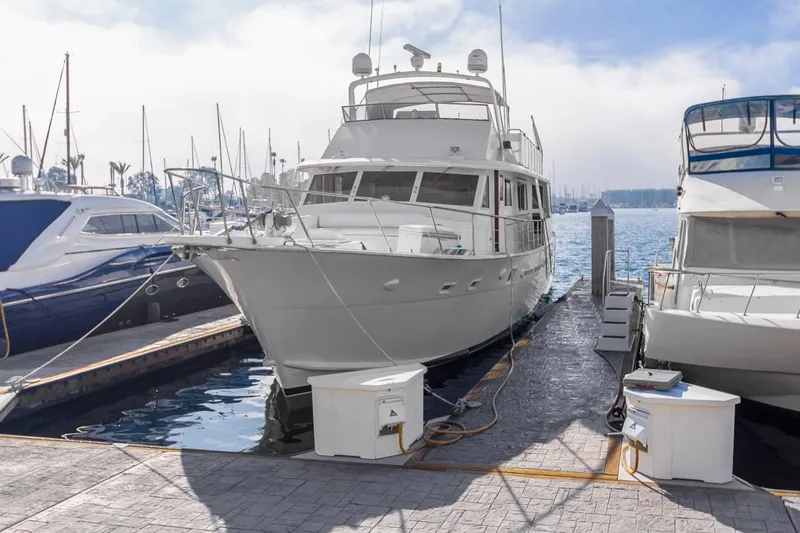  Yacht Photos Pics 1981 Hatteras Extended Deckhouse yacht docked at marina, surrounded by other boats.