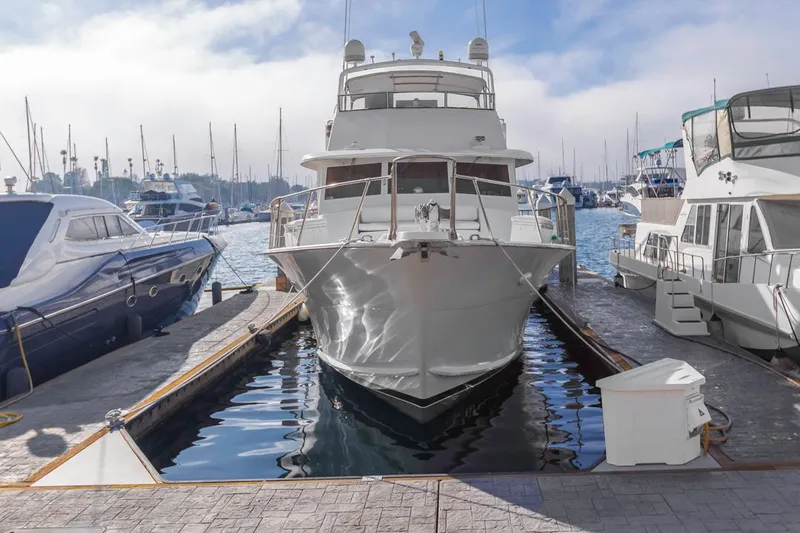  Yacht Photos Pics 1981 Hatteras Extended Deckhouse yacht docked at marina, surrounded by other boats.
