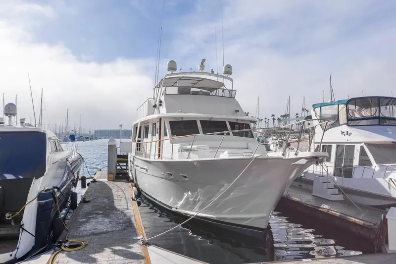  Yacht Photos Pics 1981 Hatteras Extended Deckhouse yacht docked at marina, surrounded by other boats.
