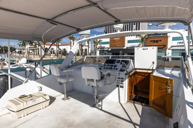  Yacht Photos Pics 1981 Hatteras Extended Deckhouse yacht helm with dual seats and marina view.