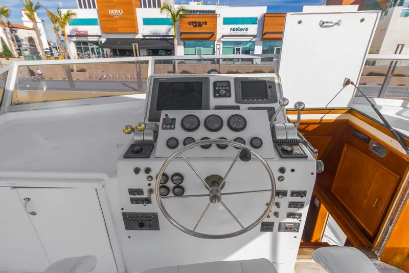  Yacht Photos Pics 1981 Hatteras Extended Deckhouse yacht helm with steering wheel and control panels.