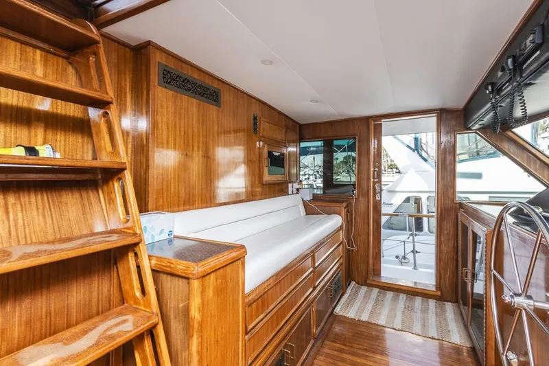  Yacht Photos Pics Interior of 1981 Hatteras Extended Deckhouse yacht with wooden finishes and seating area.