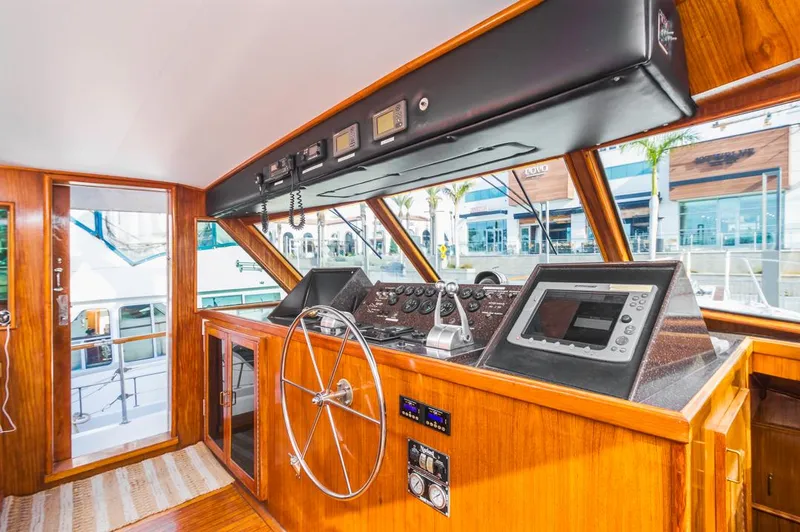  Yacht Photos Pics Interior helm of 1981 Hatteras Extended Deckhouse yacht with modern navigation equipment.