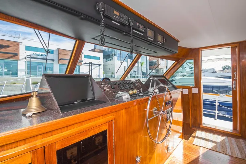  Yacht Photos Pics Interior of 1981 Hatteras Extended Deckhouse yacht with wooden helm and navigation equipment.