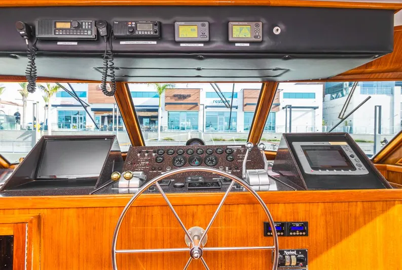  Yacht Photos Pics 1981 Hatteras Extended Deckhouse helm with navigation equipment and wooden steering wheel.