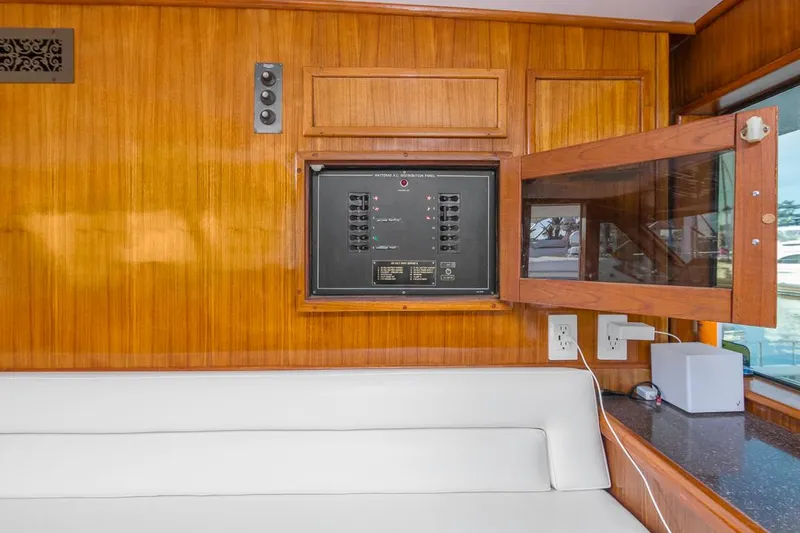  Yacht Photos Pics Interior of 1981 Hatteras Extended Deckhouse with wood paneling and control panel.