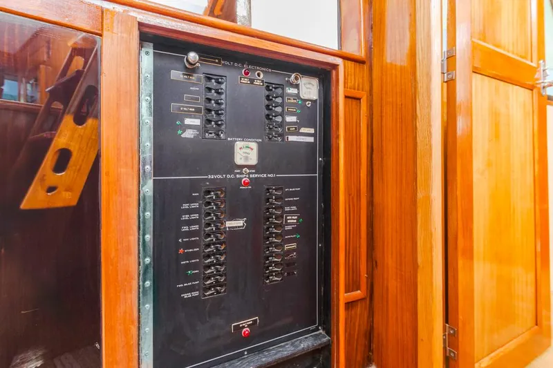  Yacht Photos Pics Electrical panel on 1981 Hatteras Extended Deckhouse yacht, surrounded by wooden cabinetry.