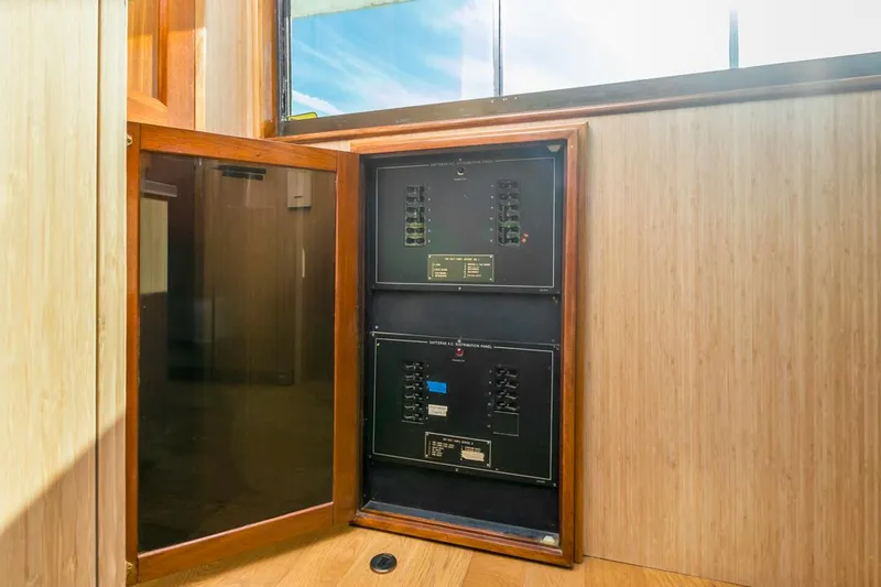  Yacht Photos Pics Electrical panel inside 1981 Hatteras Extended Deckhouse yacht, wooden interior, open cabinet.