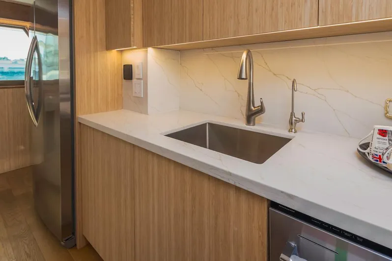  Yacht Photos Pics Modern kitchen in 1981 Hatteras Extended Deckhouse with sleek cabinetry and stainless steel appliances.