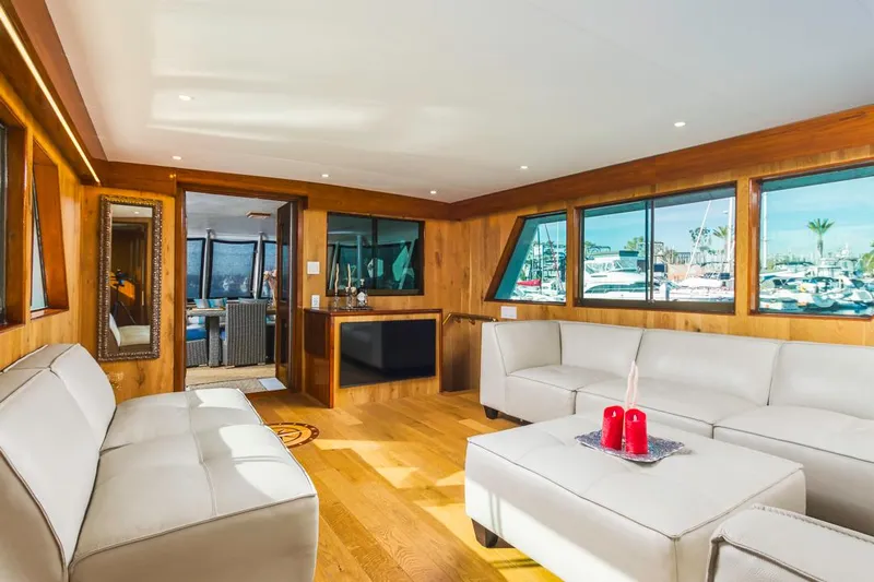  Yacht Photos Pics Luxurious 1981 Hatteras Extended Deckhouse interior with modern furnishings and large windows.