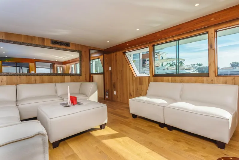  Yacht Photos Pics Luxurious 1981 Hatteras Extended Deckhouse interior with modern white seating and wood paneling.