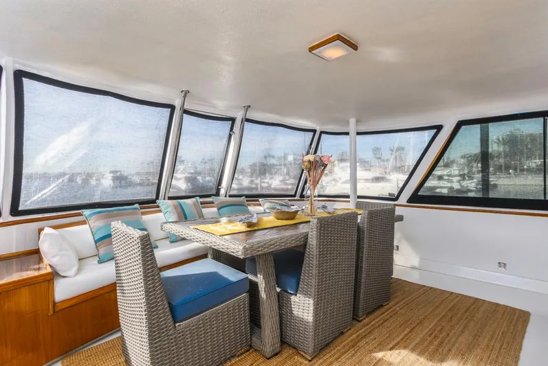  Yacht Photos Pics Interior of 1981 Hatteras Extended Deckhouse with dining area and panoramic windows.