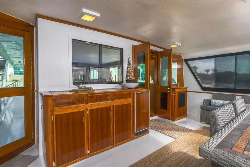  Yacht Photos Pics 1981 Hatteras Extended Deckhouse interior with wooden cabinets and wicker seating.