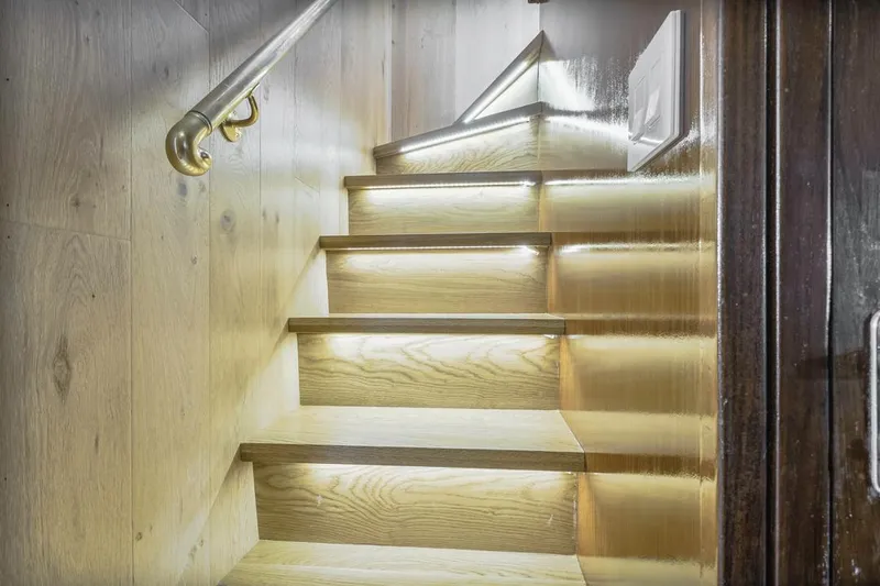  Yacht Photos Pics Wooden staircase with modern lighting in 1981 Hatteras Extended Deckhouse yacht.